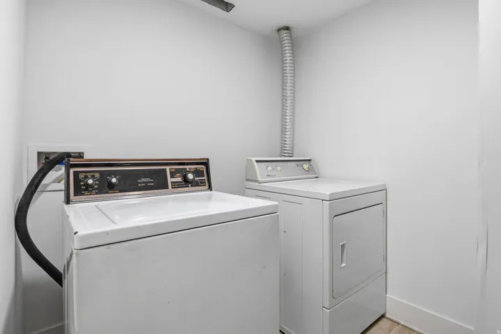 basement  laundry area with a washer and dryer