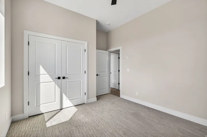 Neutral toned room featuring a textured carpet and light-colored walls