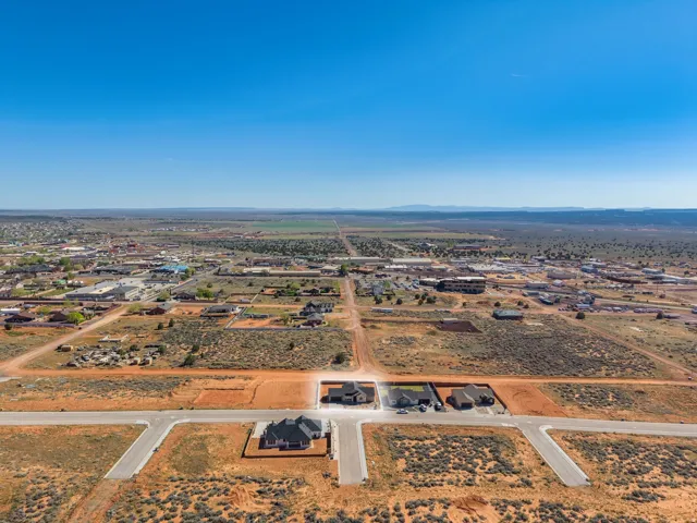 New construction homes situated on generous land parcels within a developing neighborhood, featuring paved street access
