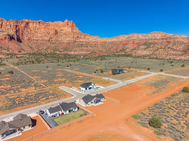 Expansive desert landscape featuring red rock mountain formations