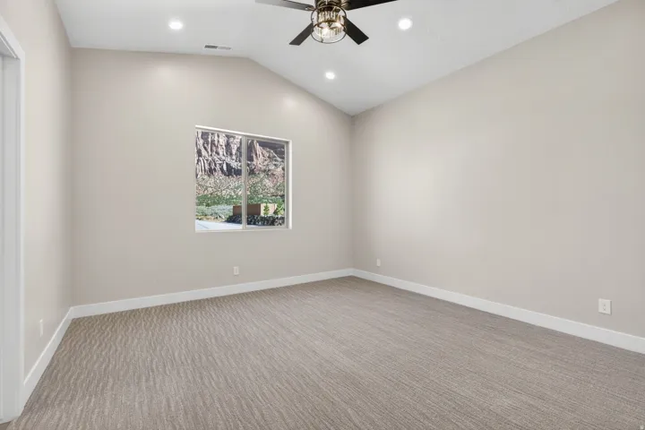 Vaulted ceiling with recessed lighting and a ceiling fan