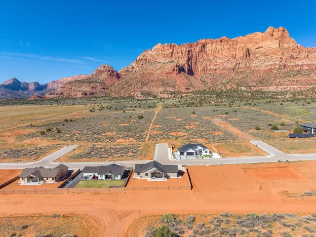 Expansive residential development featuring multiple single-story homes and undeveloped land parcels