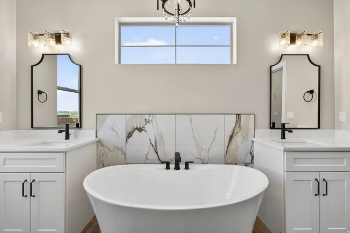 Freestanding soaking tub with a striking tile accent wall