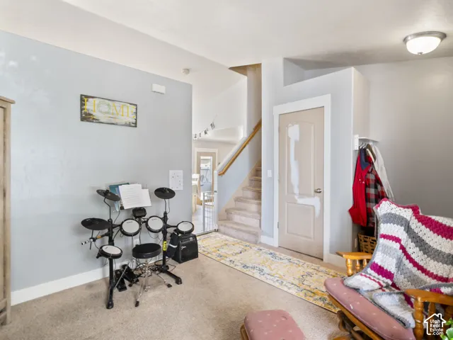Carpeted flooring throughout, recessed lighting, and a neutral wall color
