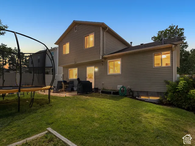 Rear exterior of the home, featuring horizontal siding and a composition shingle roof