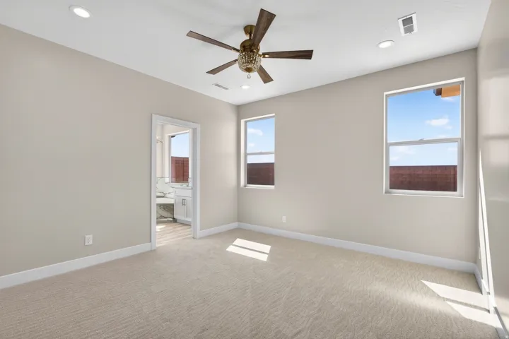 Carpeted room with recessed lighting and a ceiling fan