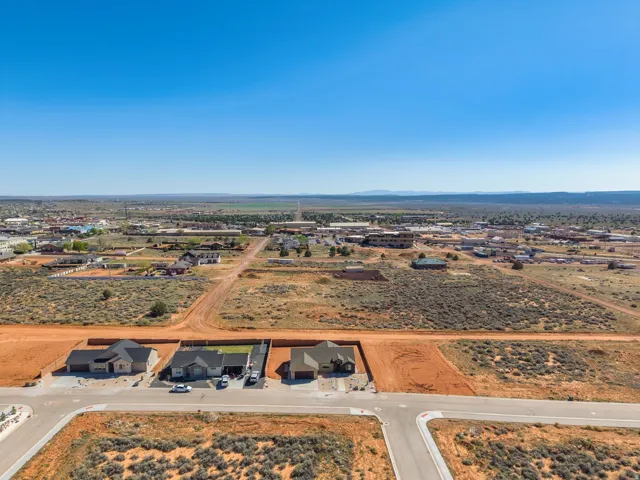 Aerial perspective showcasing a developing residential area with paved streets and established homes