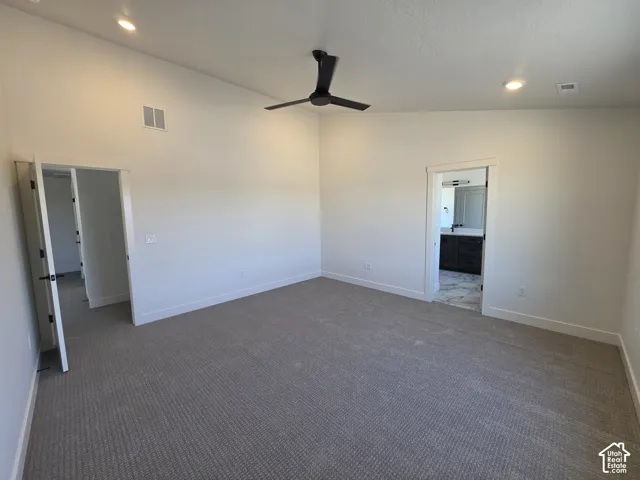 Spacious room featuring vaulted ceilings, recessed lighting, and a contemporary ceiling fan