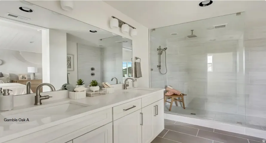 Dual vanity with white cabinetry, integrated sinks, and brushed nickel fixtures> This home is To Be Built and the pictures are of a previous home.