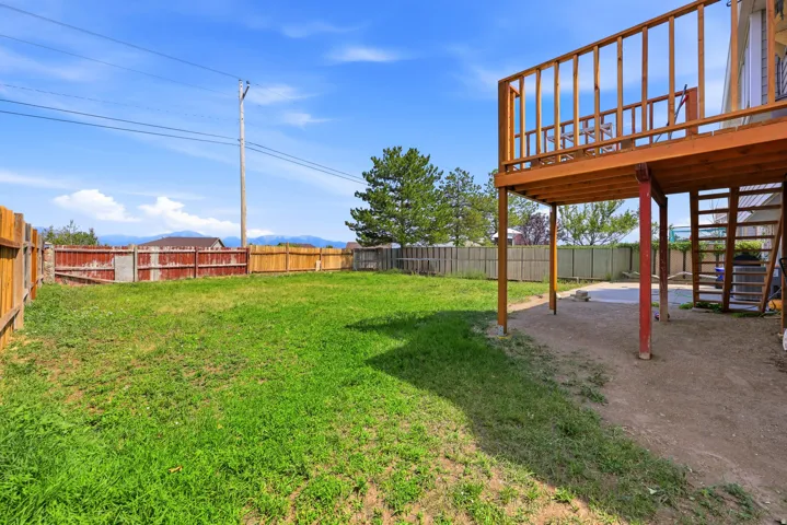 Expansive grassy yard area with perimeter fencing