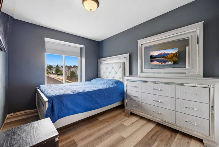 Light wood-finish flooring complements the neutral wall color