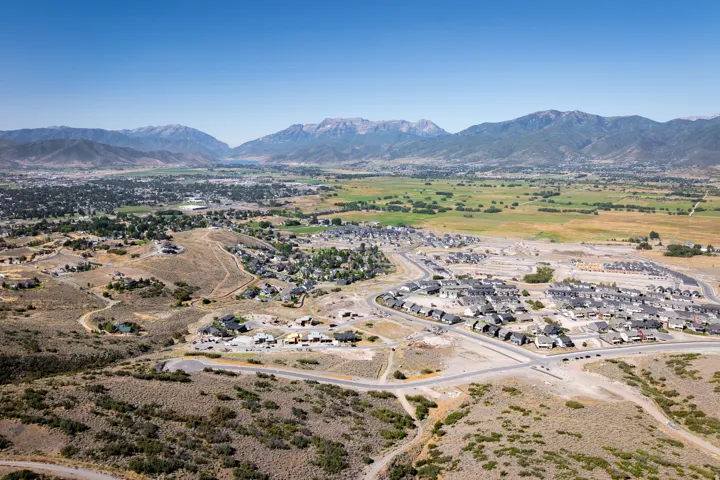 Expansive aerial landscape featuring established residential neighborhoods and new construction development