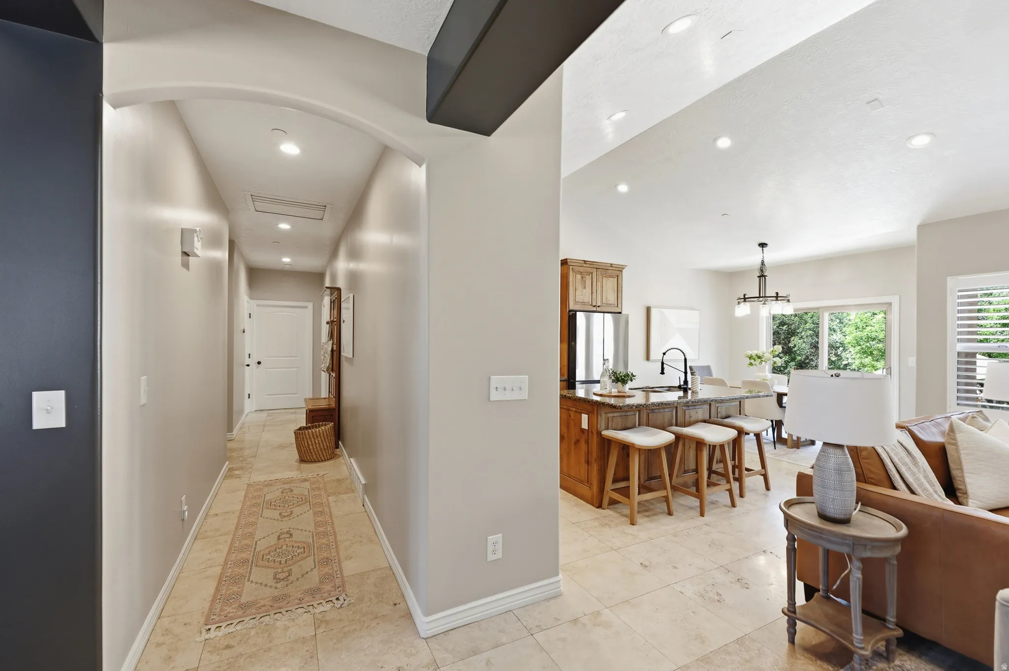 Open-concept living area with vaulted ceilings and recessed lighting