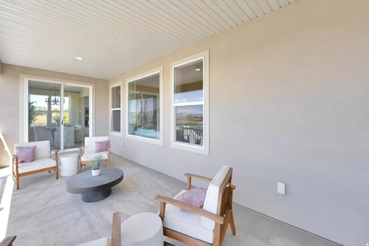 Covered patio featuring a concrete slab and stucco exterior