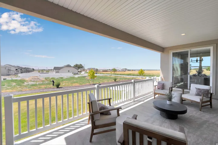 Covered patio featuring concrete flooring and a white railing