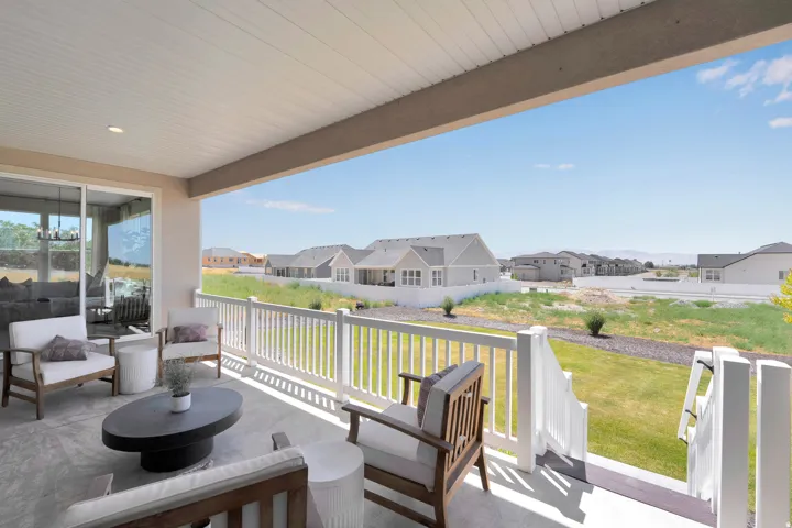Covered patio featuring a solid ceiling with recessed lighting, concrete flooring, and white railing