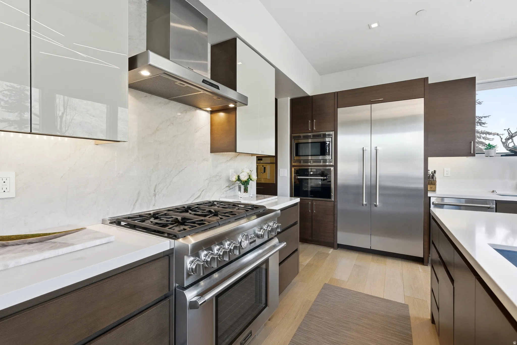 Gourmet kitchen with professional-grade stainless steel range, built-in double ovens, and a large stainless steel refrigerator