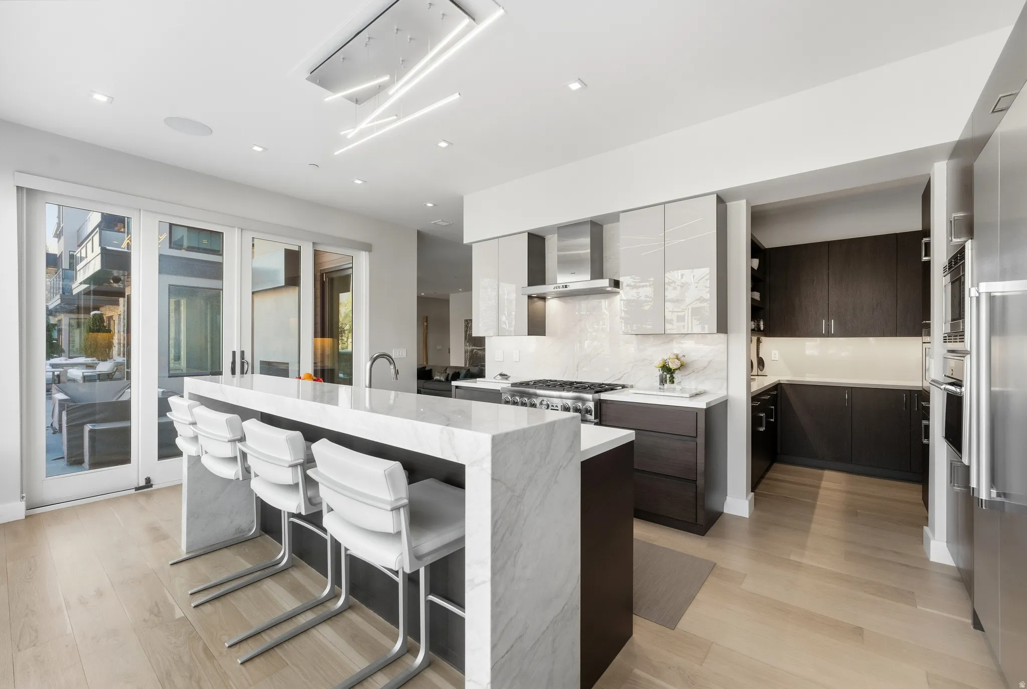 Modern kitchen with a waterfall island featuring a light-toned countertop
