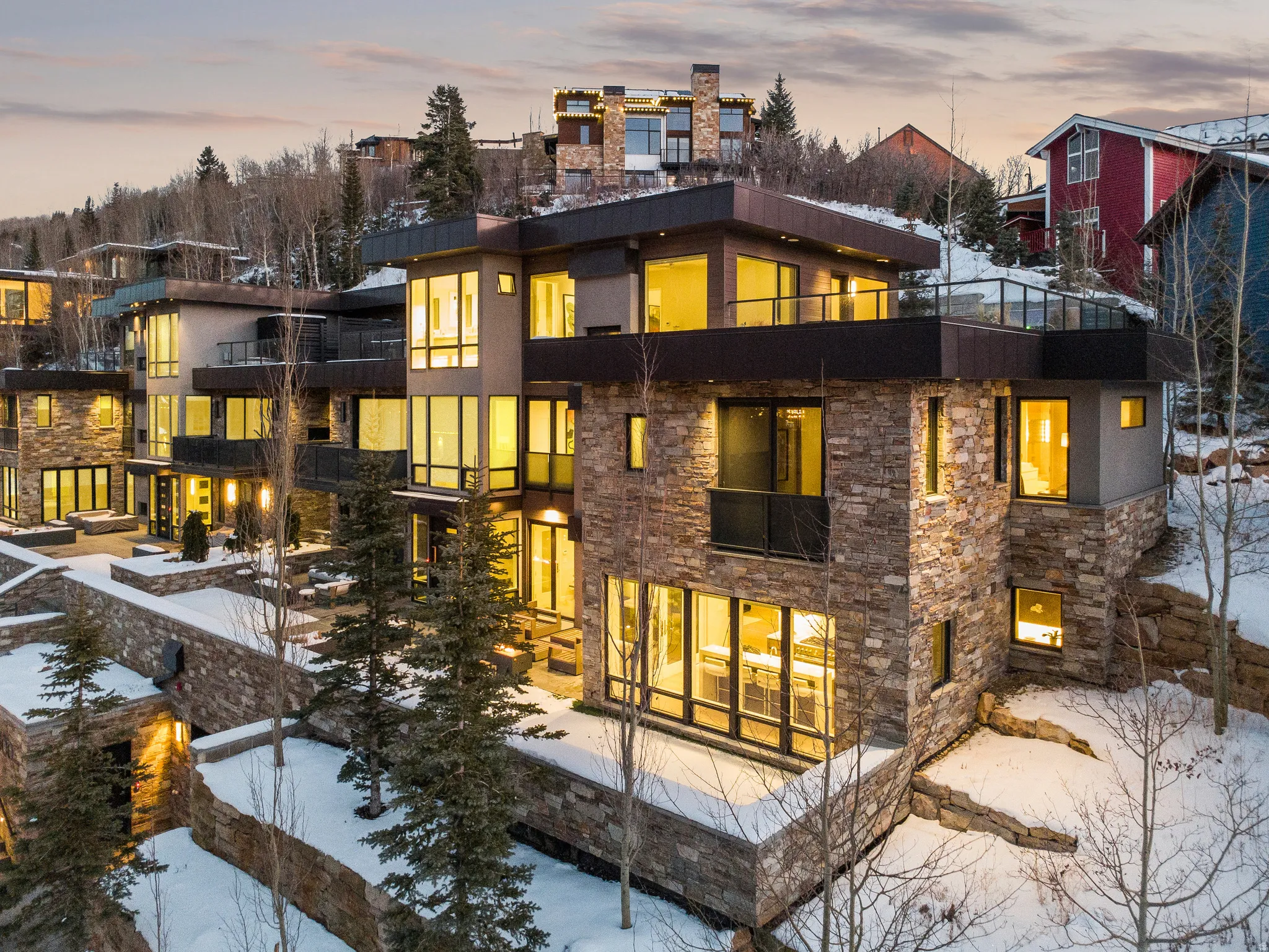 Contemporary multi-level residence featuring extensive stacked stone and stucco exterior finishes
