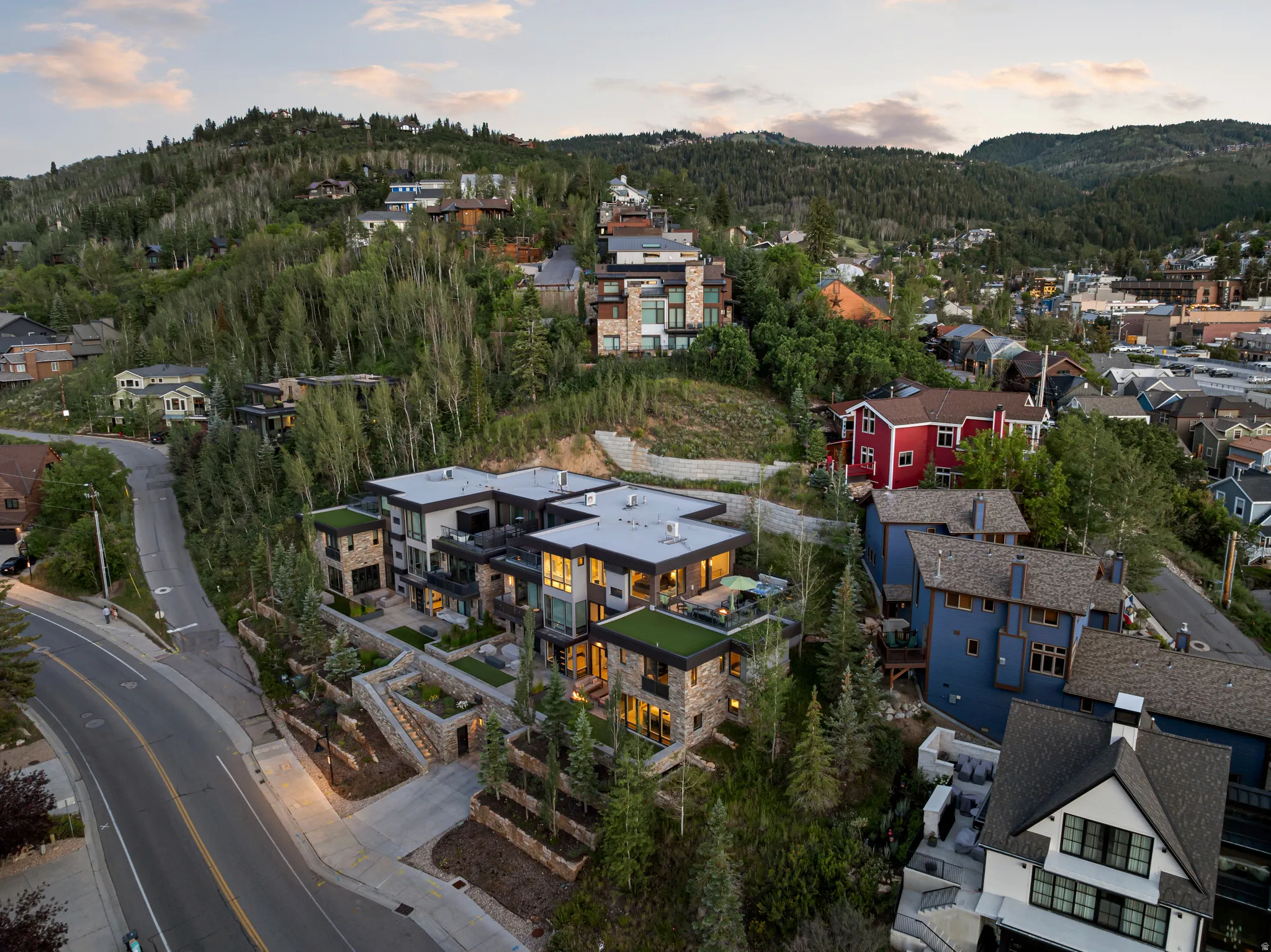 Contemporary multi-level structure featuring stone and stucco facade