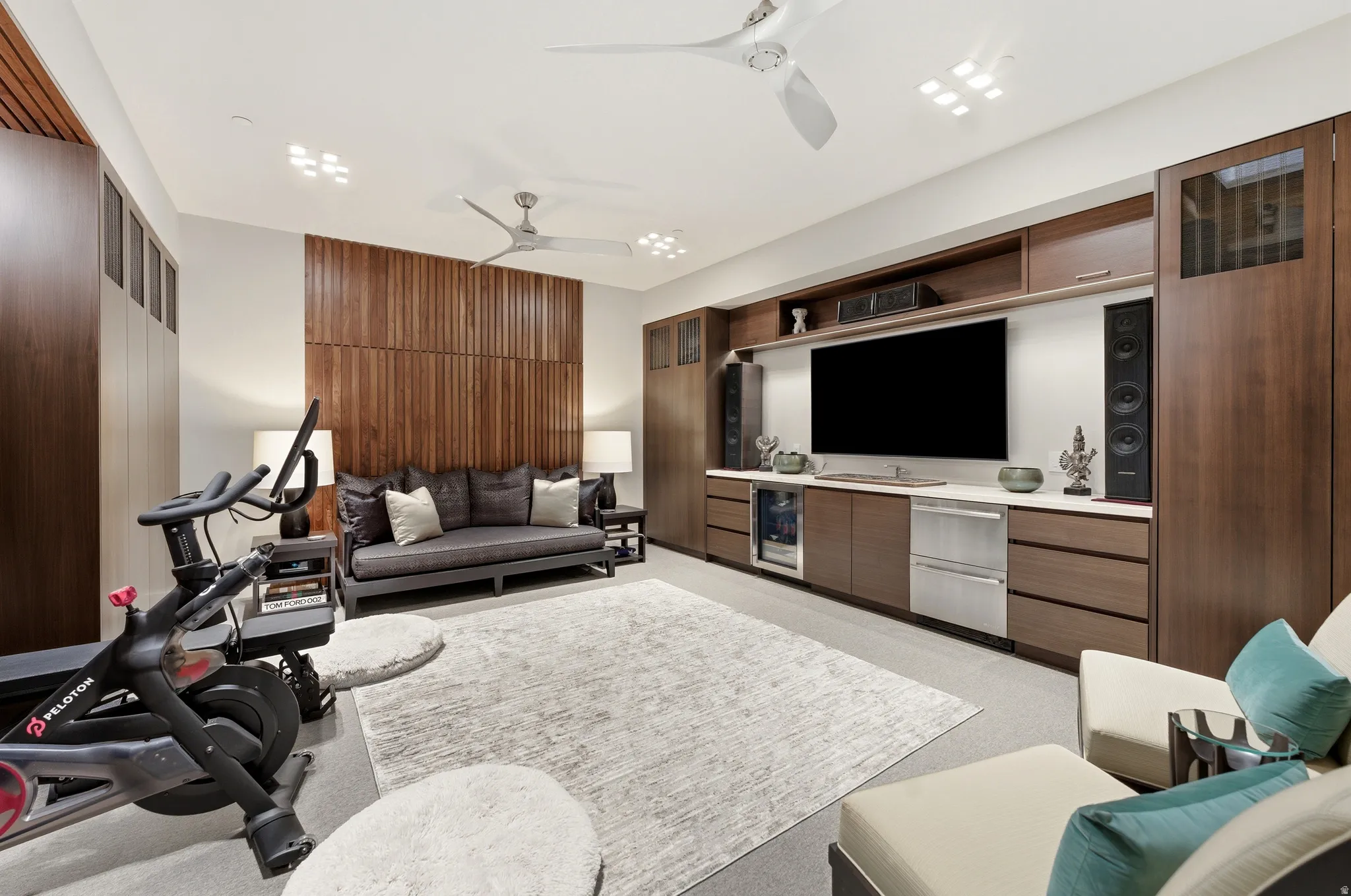 Integrated media wall featuring a large screen, built-in speakers, and multiple storage compartments