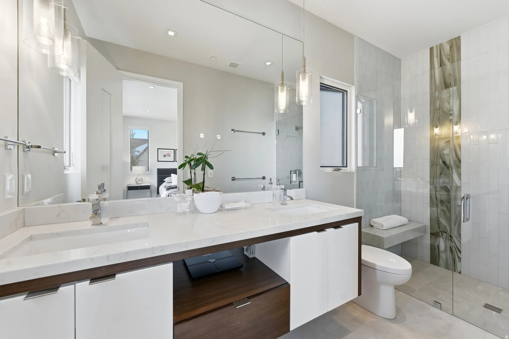 Double vanity with integrated sinks and white countertops
