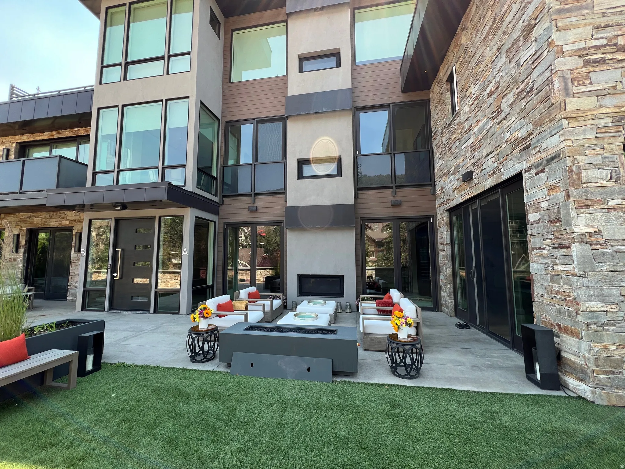 Exterior facade featuring mixed material construction, floor-to-ceiling windows, and a multi-level design