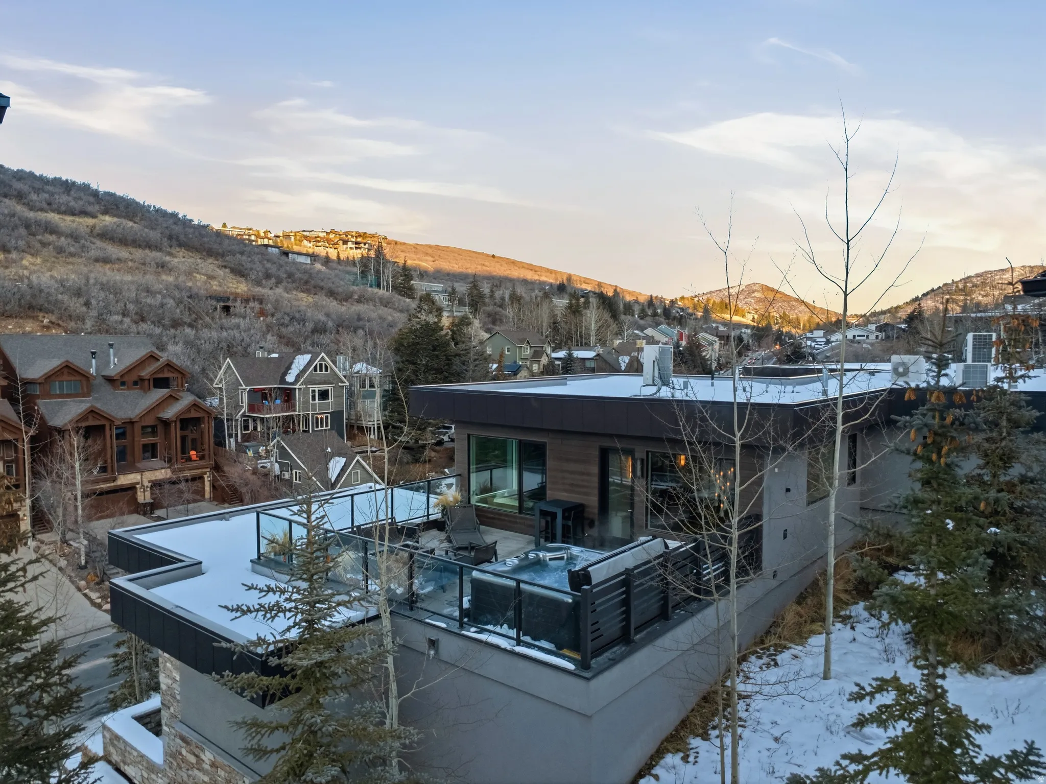 Modern architectural residence featuring multi-level construction and a flat roofline