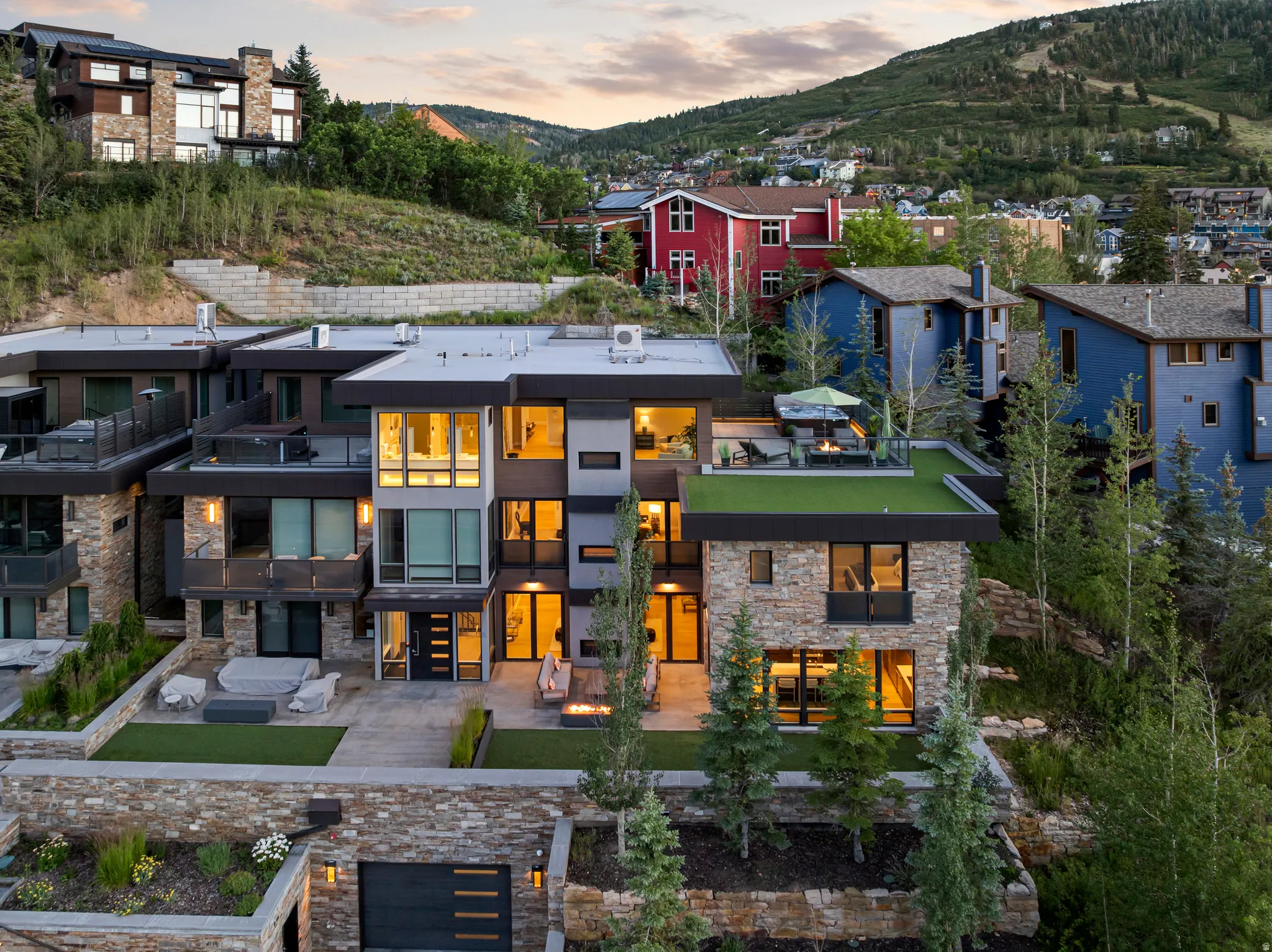 Multi-level modern residence featuring stone and dark paneling exterior