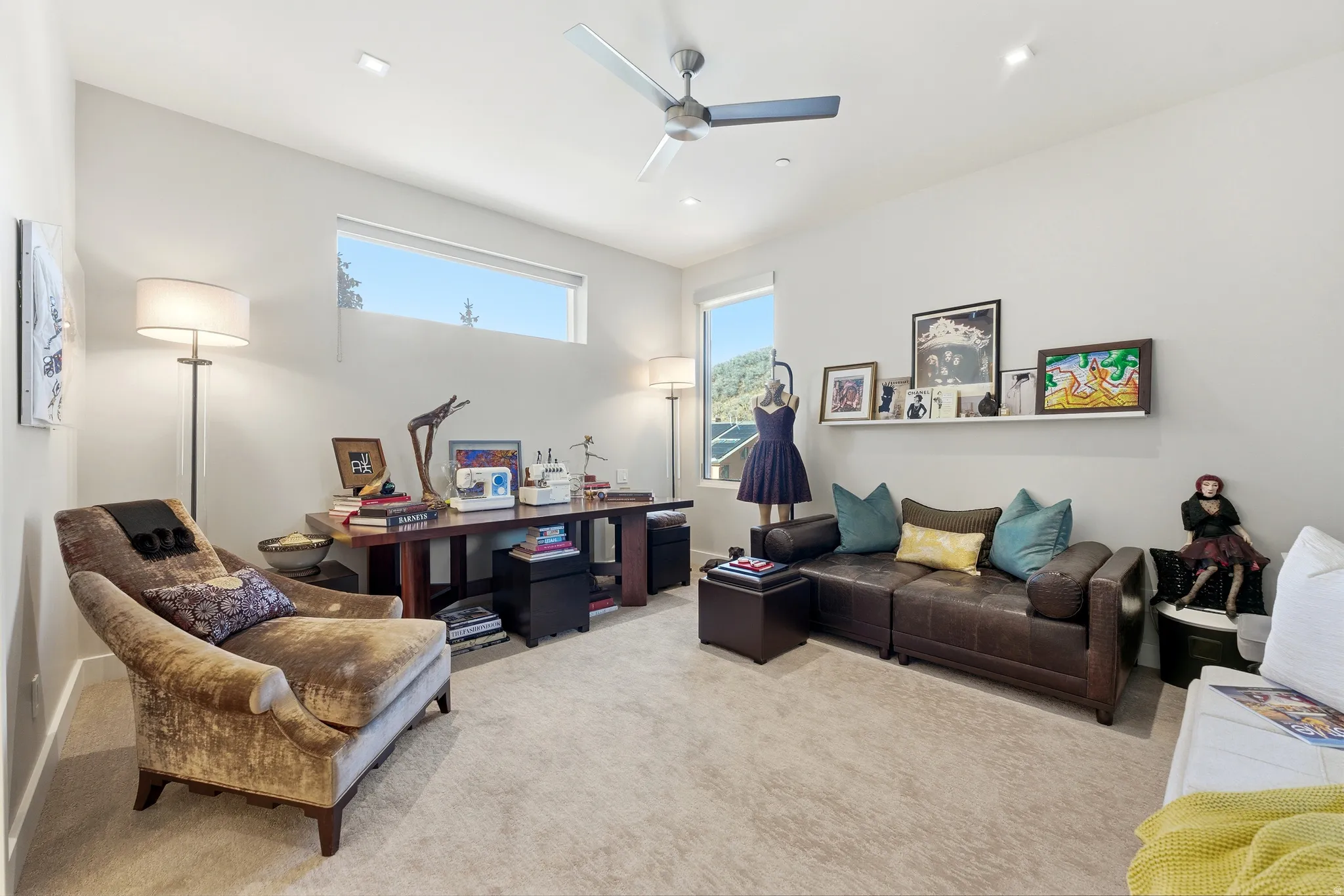 Spacious room featuring light-colored carpeting and high ceilings with recessed lighting