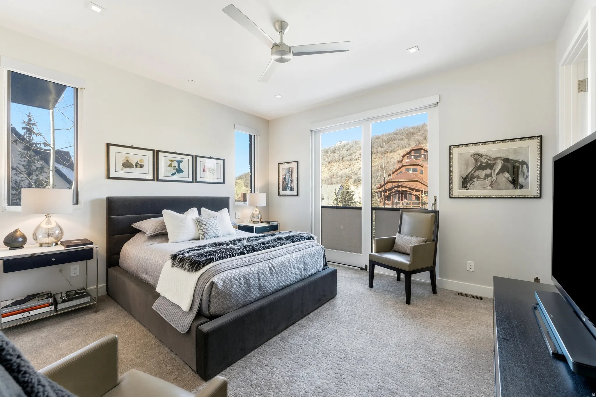 Carpeted bedroom with a built-in ceiling fan, recessed lighting, and a sliding glass door providing exterior access