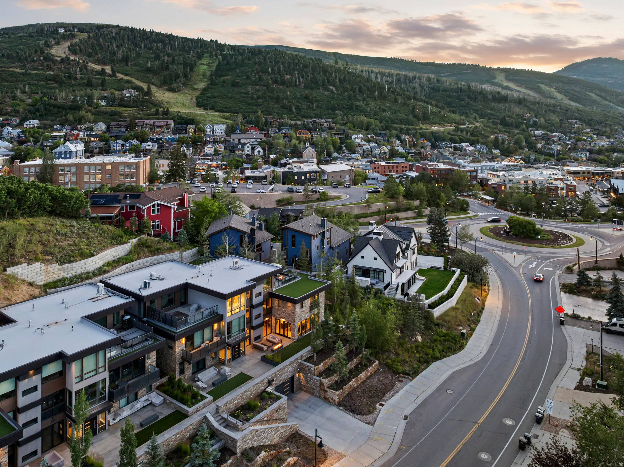 Contemporary multi-level residences featuring flat roofs, multiple balconies, and stone retaining walls