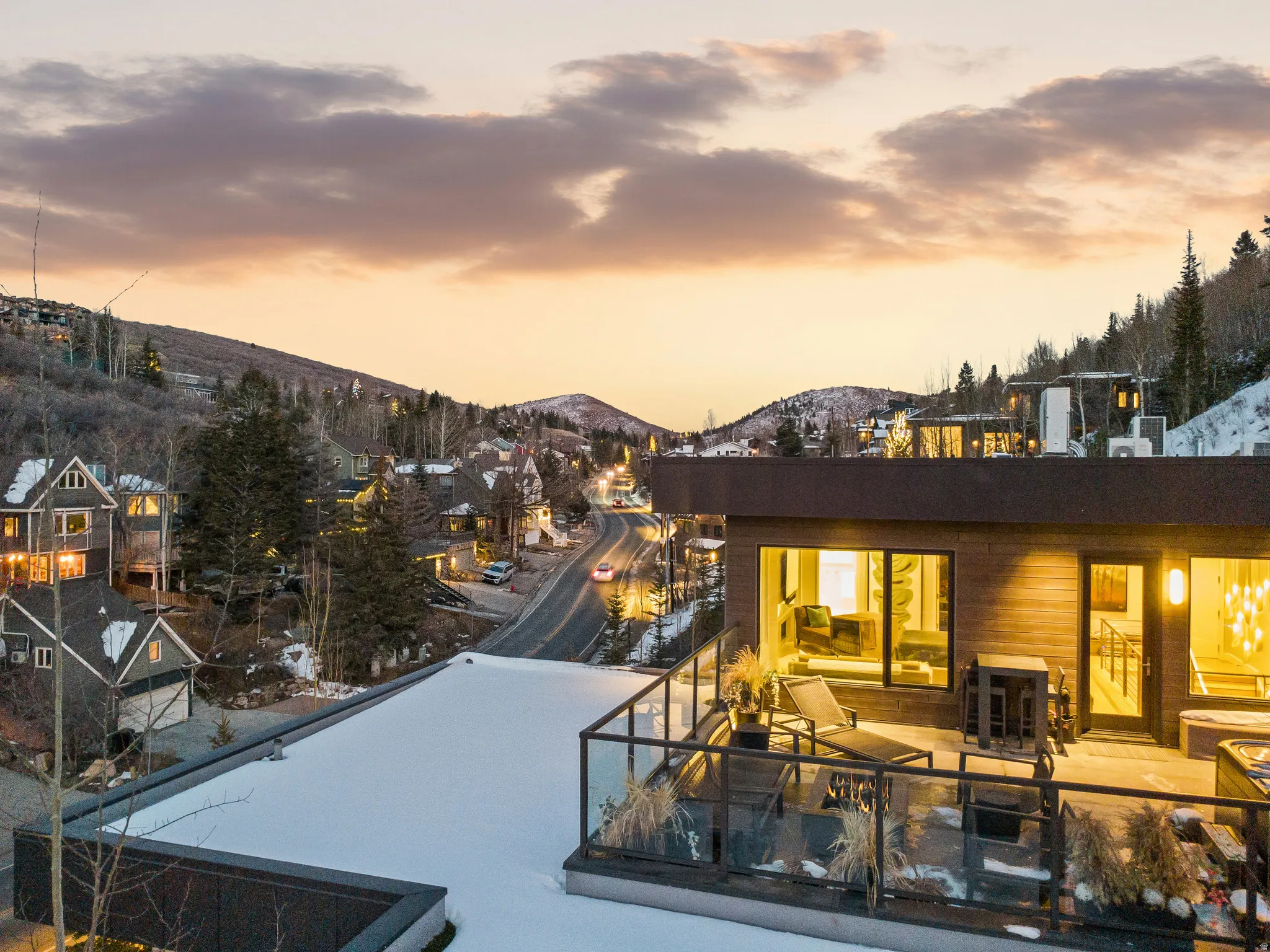 Rooftop deck featuring glass railings, a lounge area, and direct access to interior spaces through large windows and a glass door