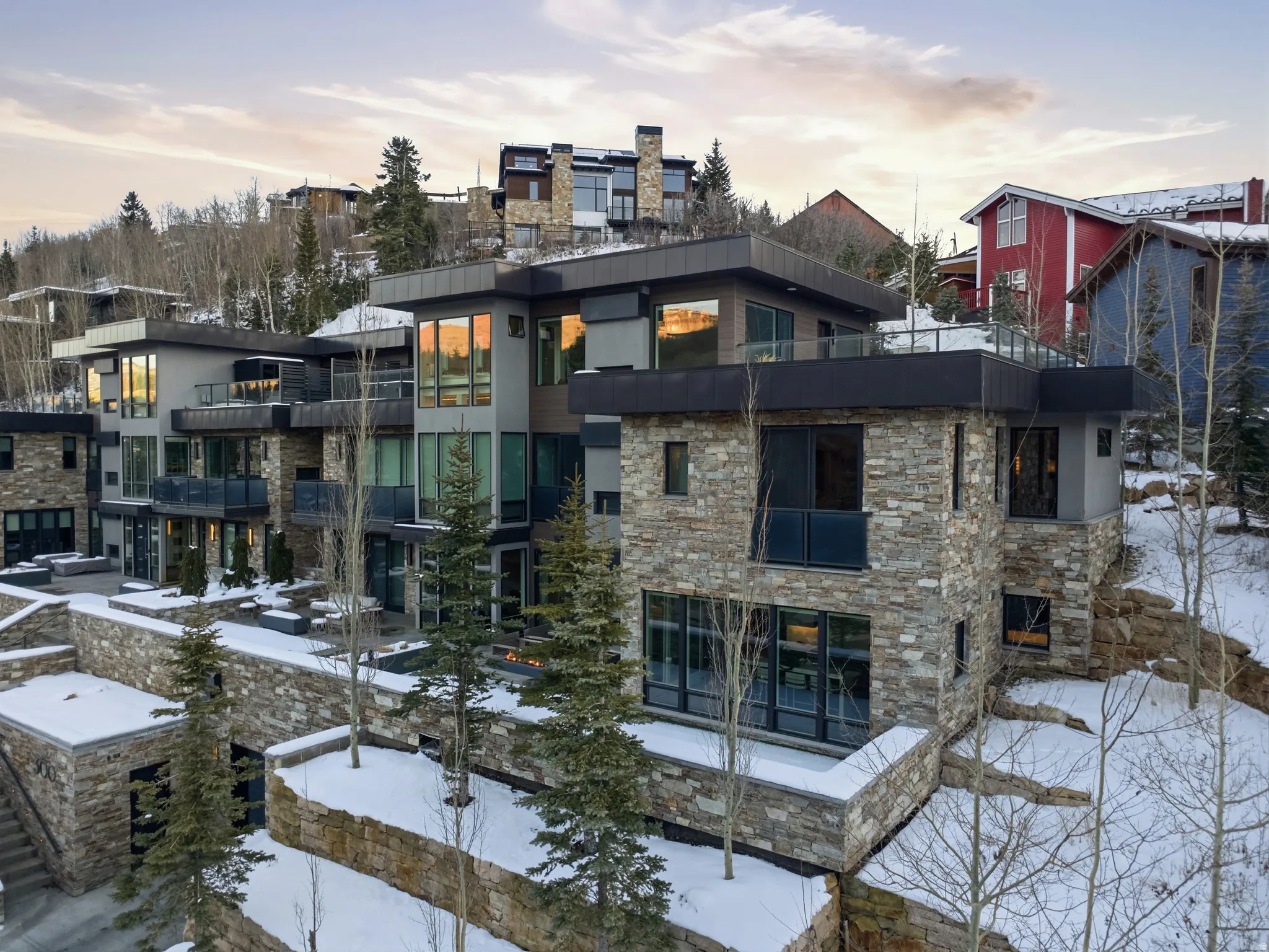 Modern multi-level residence featuring stone and stucco exterior finishes