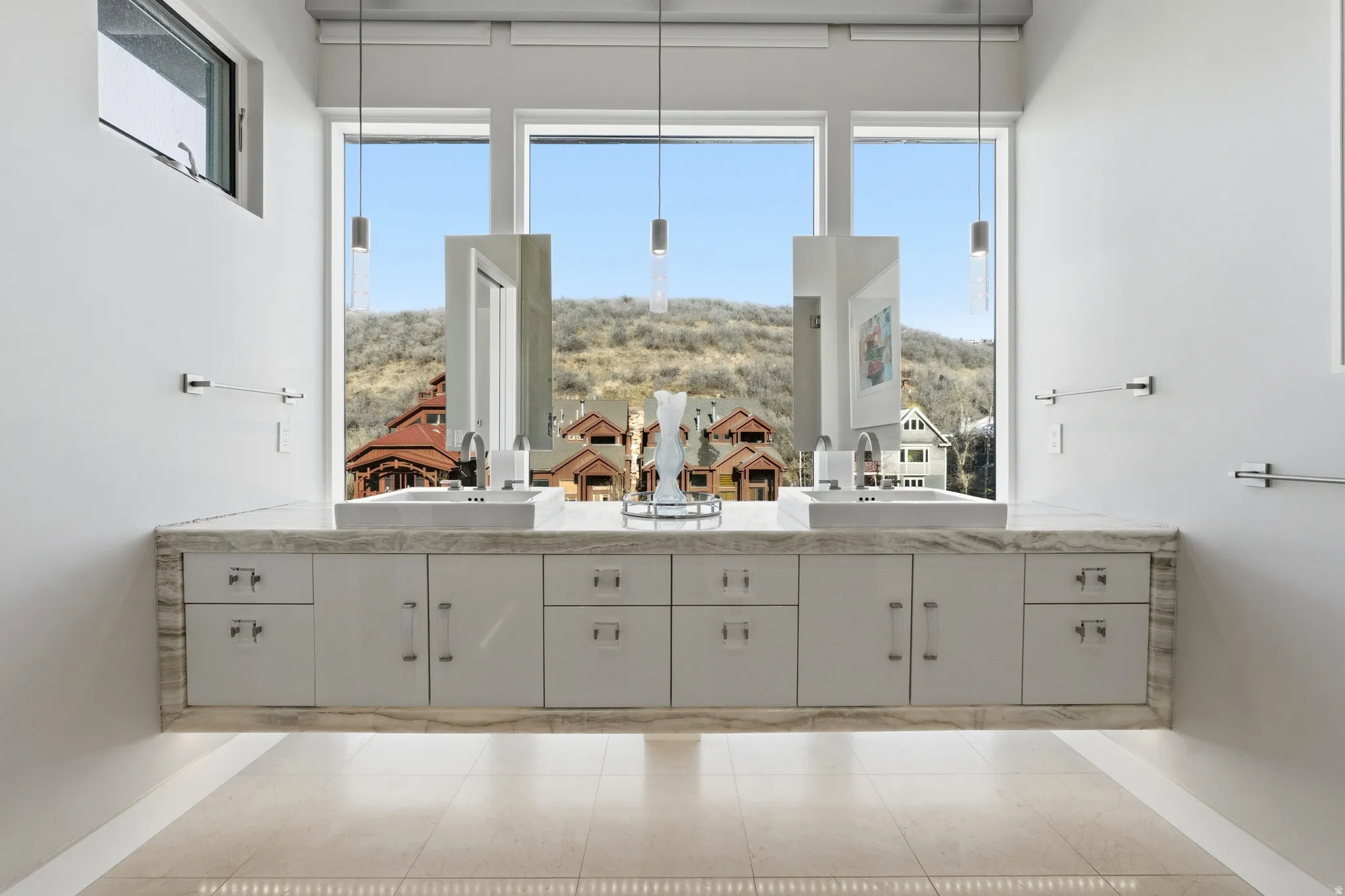 Dual vanity featuring a stone countertop, undermount sinks, and ample cabinetry