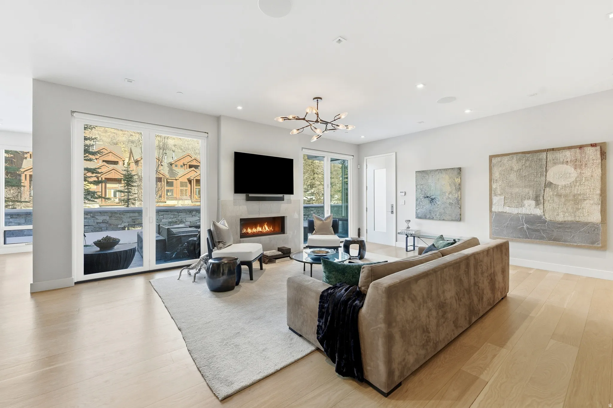 Expansive living area featuring light wood-finish flooring and recessed lighting