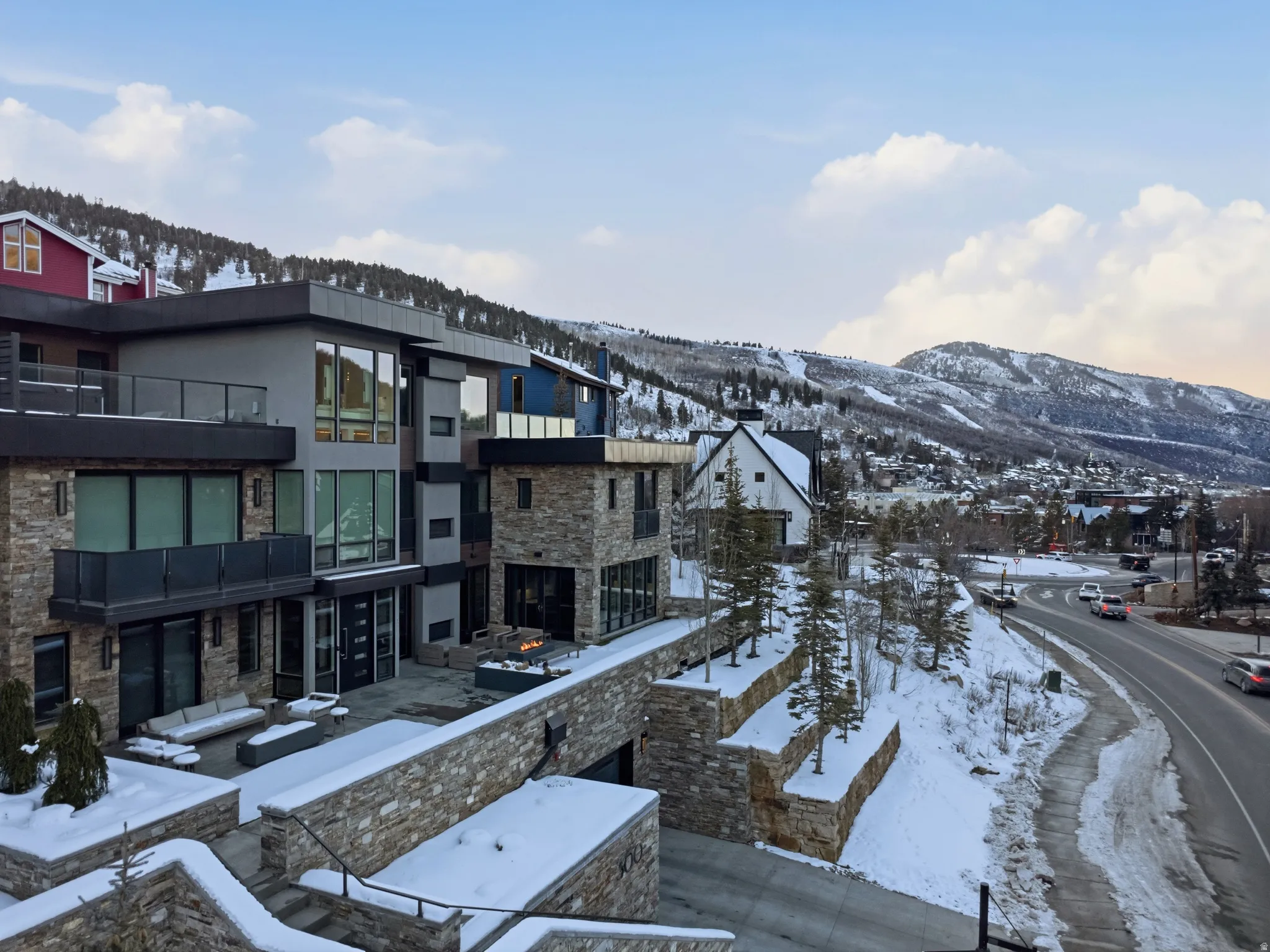 Modern multi-level residence featuring a stone and stucco exterior