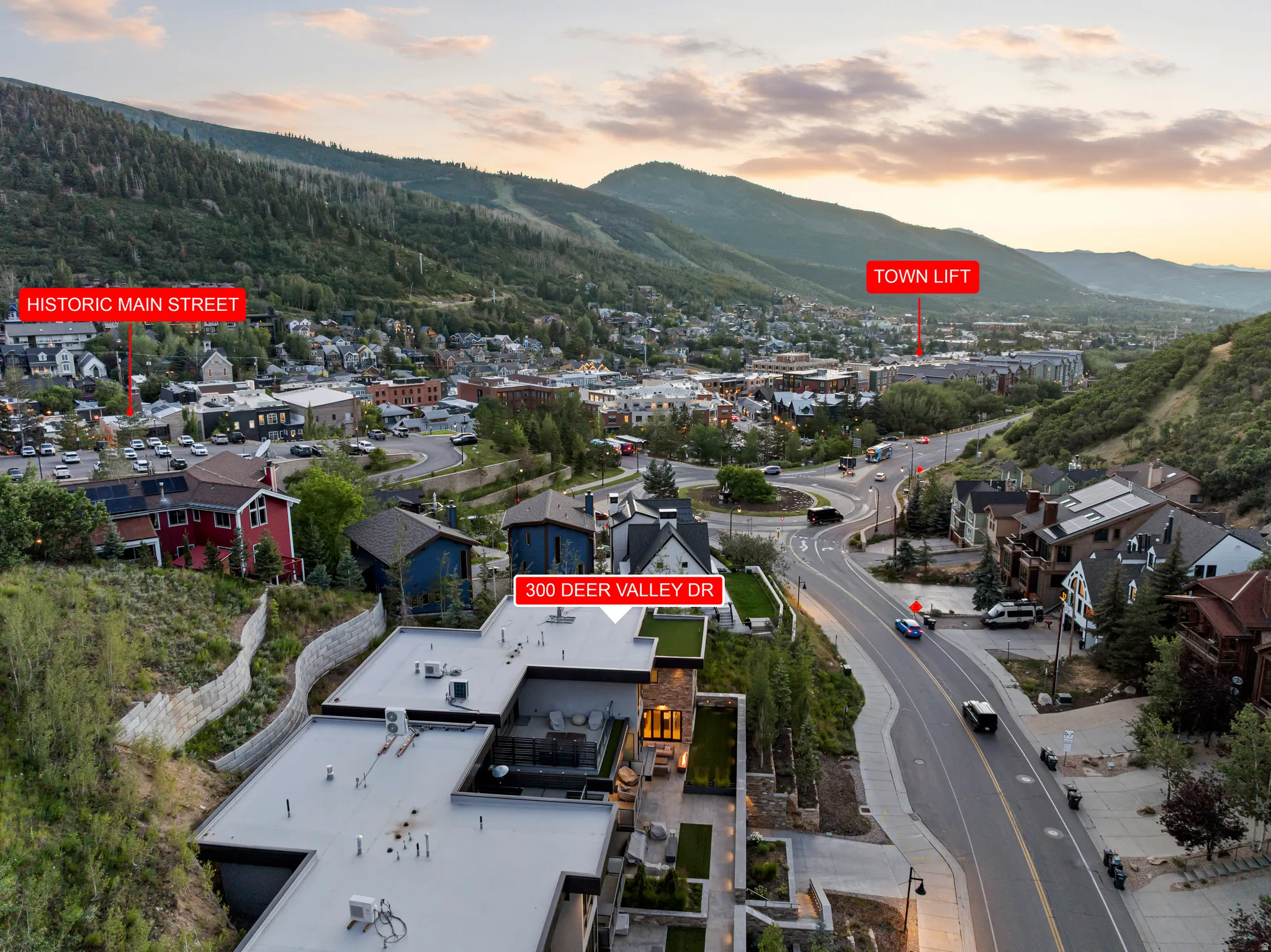 Aerial perspective showcasing the property's modern architecture with flat roofing and expansive outdoor patio areas