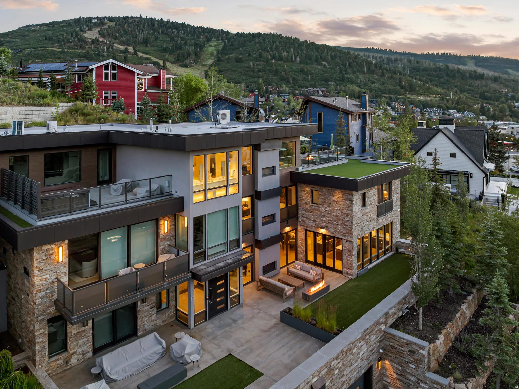 Modern multi-level residence featuring stone and panel siding