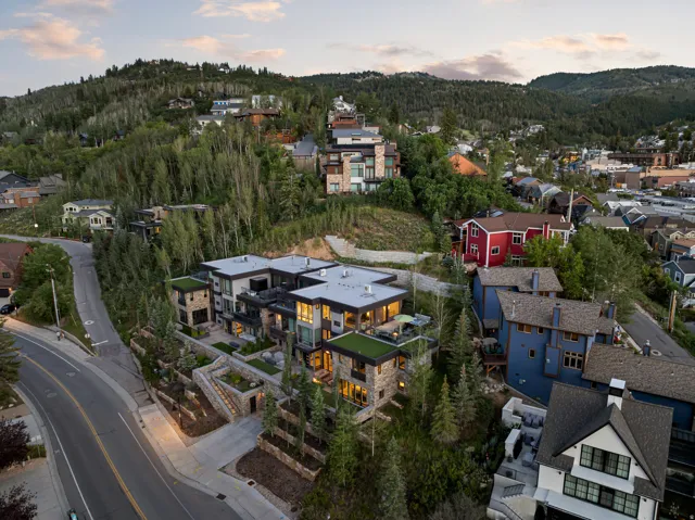 Contemporary multi-level structure featuring stone and stucco facade