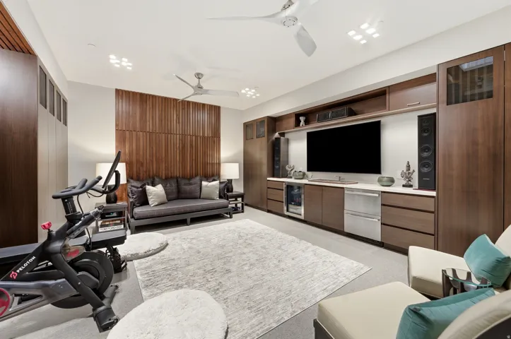 Integrated media wall featuring a large screen, built-in speakers, and multiple storage compartments