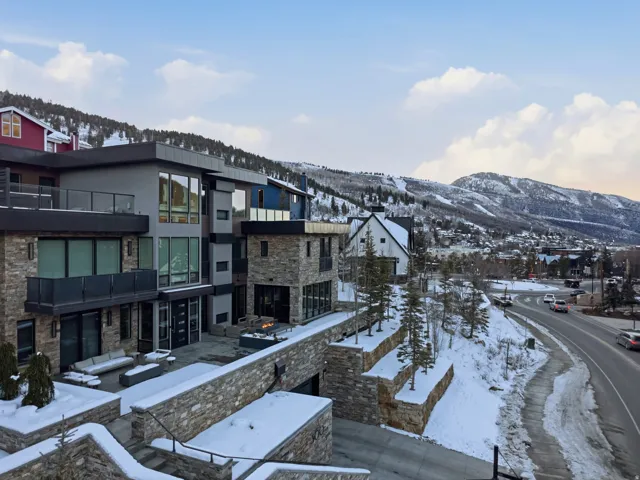 Modern multi-level residence featuring a stone and stucco exterior