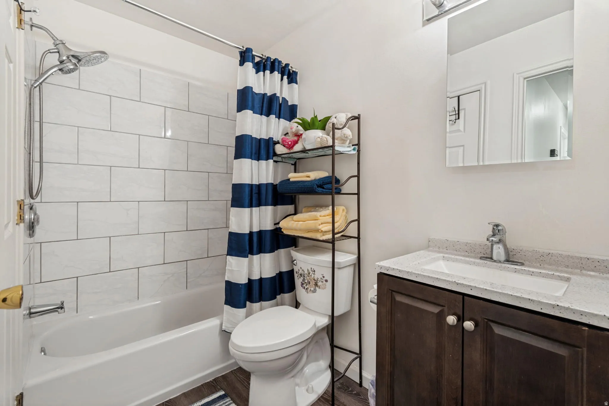 Bathtub with white subway tile surround and shower fixture