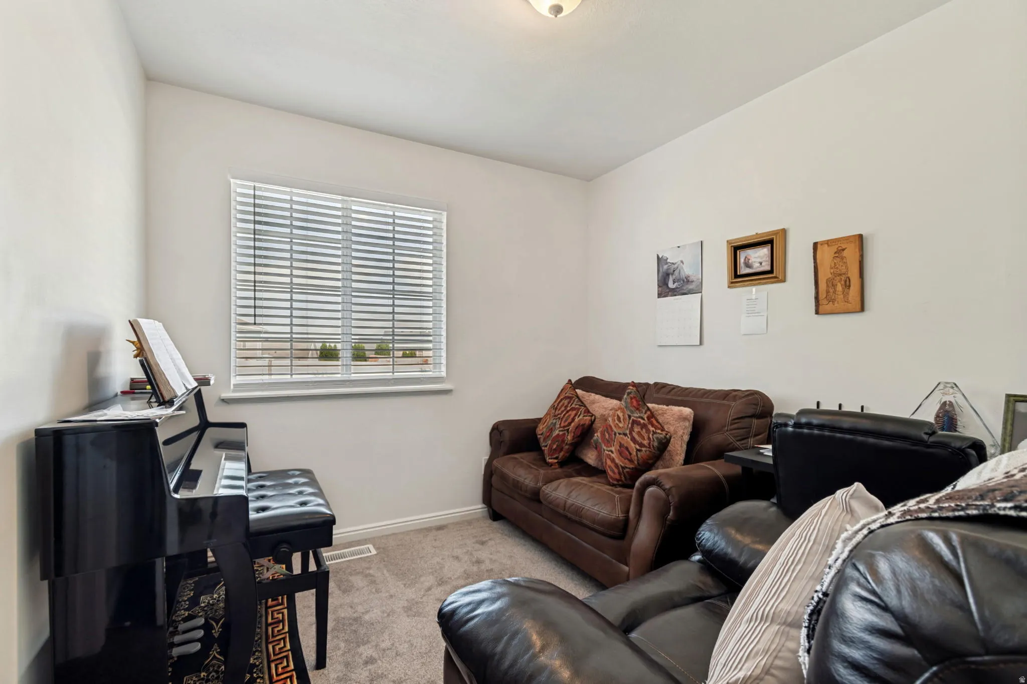 Carpeted room with a single window featuring horizontal blinds