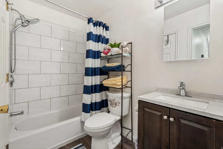 Bathtub with white subway tile surround and shower fixture