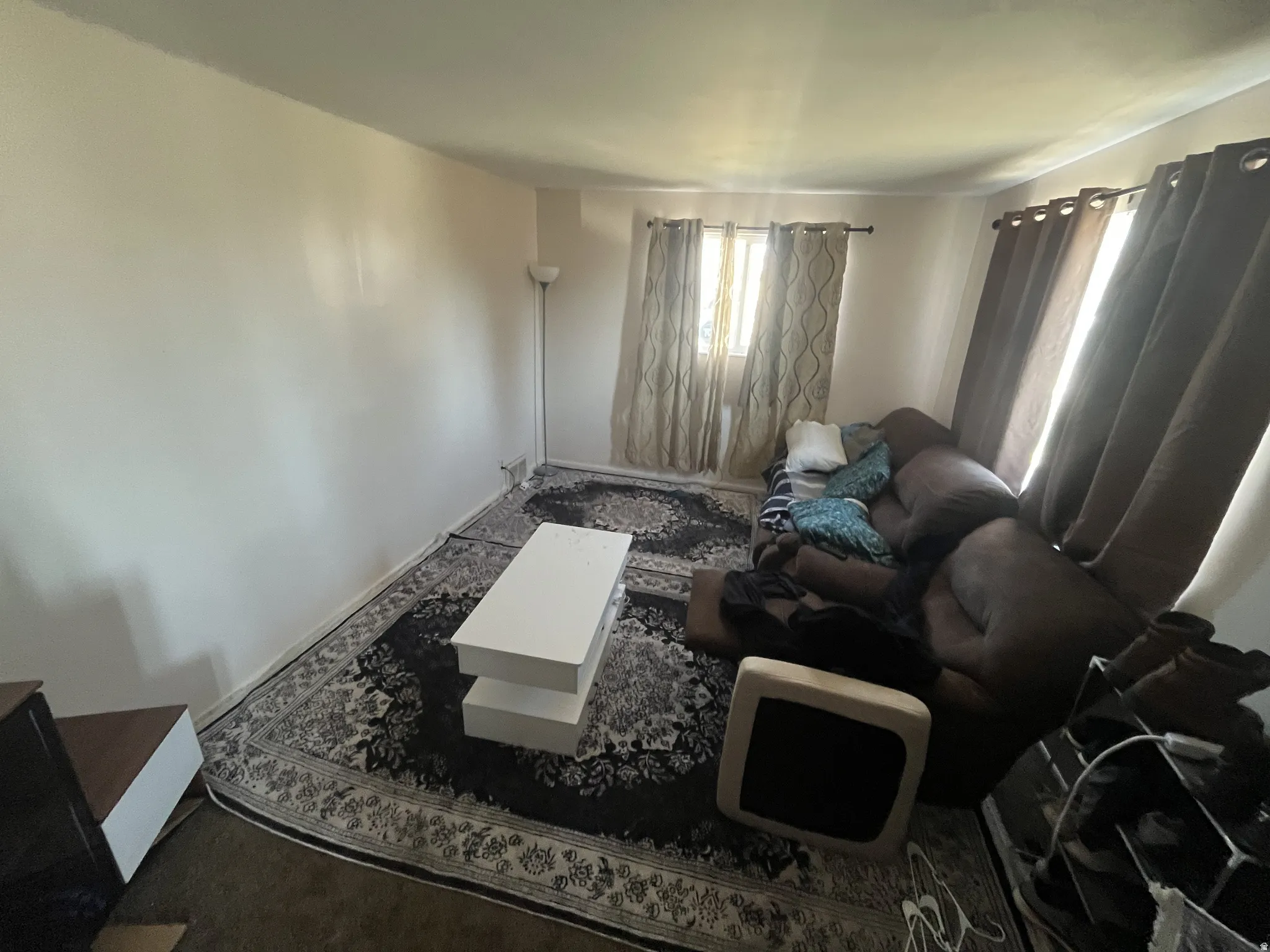 Neutral wall paint, window with natural light, and carpeted flooring