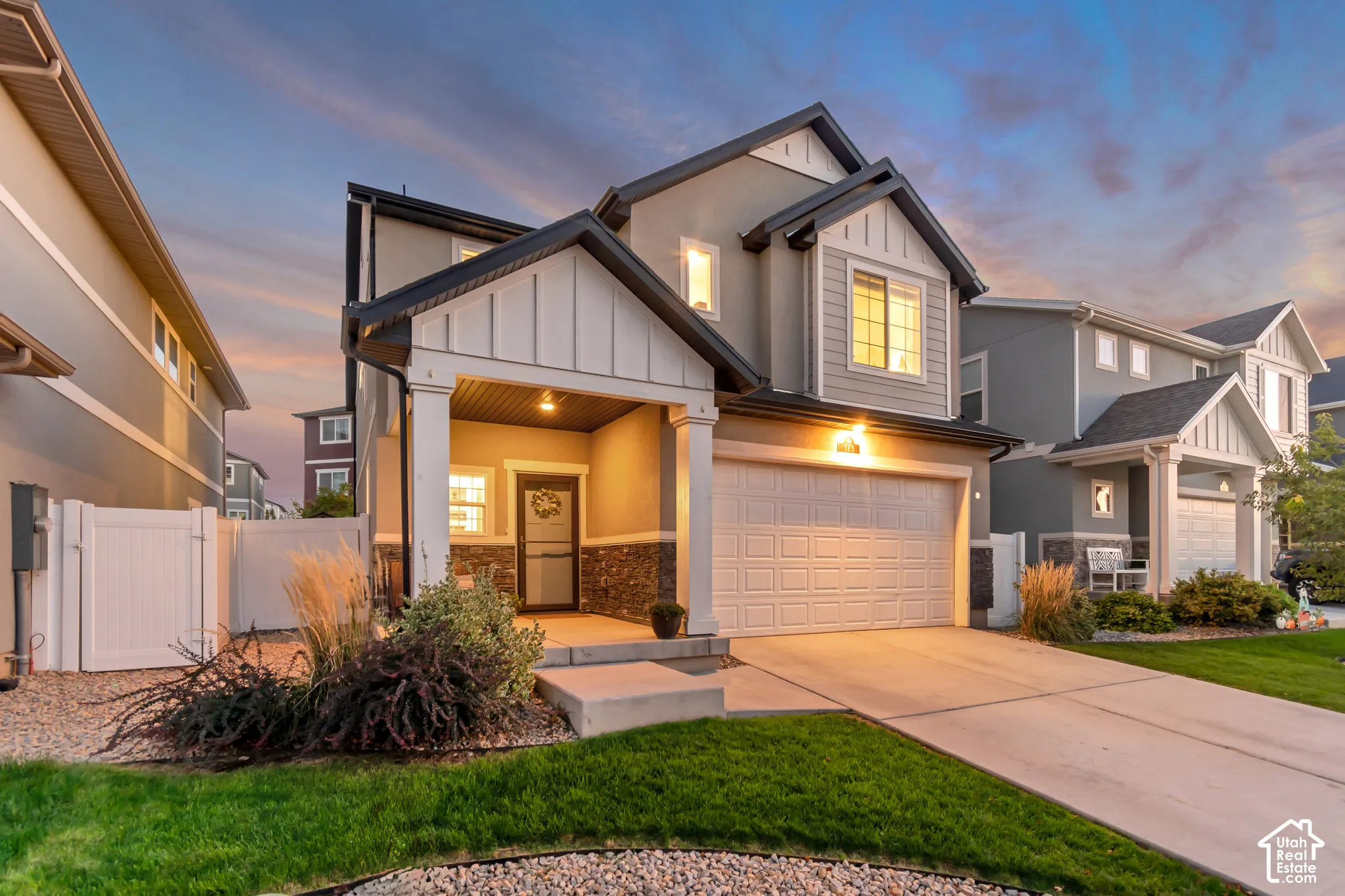 Modern two-story home featuring a charming front elevation with peaked gable roofline and mixed exterior finishes