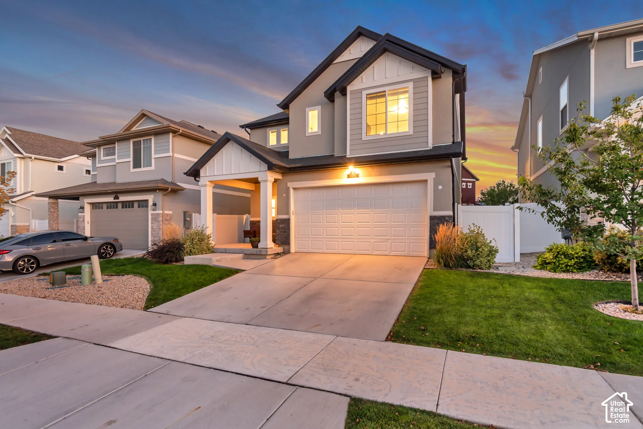 Two-story residence featuring a covered entry porch, an attached two-car garage, and a concrete driveway