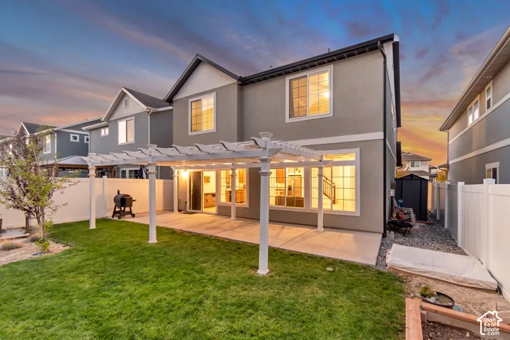 Expansive concrete patio with a white pergola structure