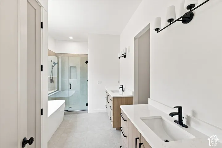 Dual wood-finish vanities with white countertops and undermount sinks
